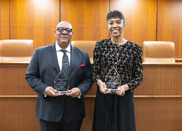 Esdaile and Avery pose smiling with their glass awards