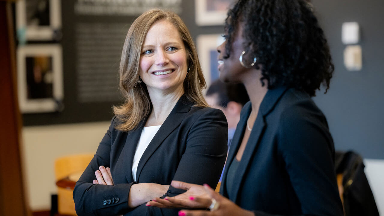 2 women speaking while walking