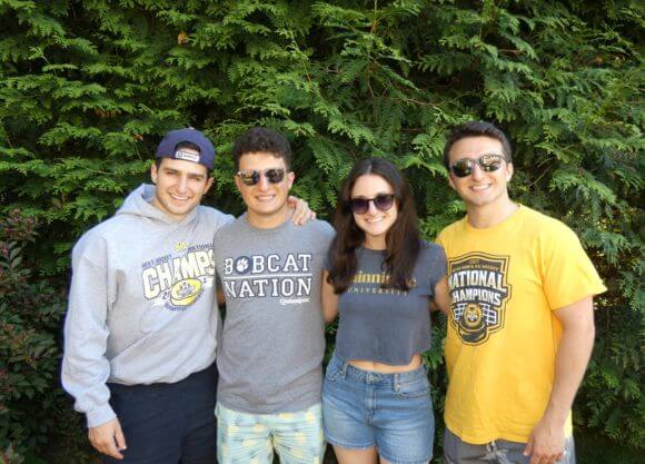 The Passanante family posing with Quinnipiac shirts