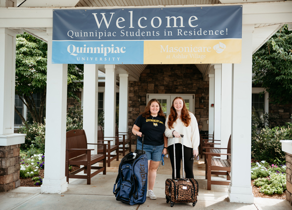 Students stand with suitcases in front of Masonicare