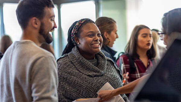 A few law students talk with professional law advisers