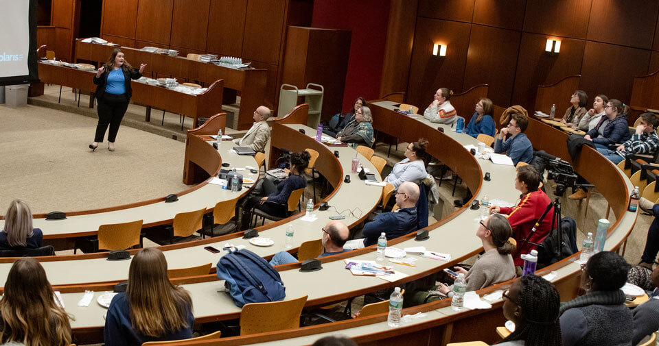 A student presents to an audience in the law ceremonial courtroom