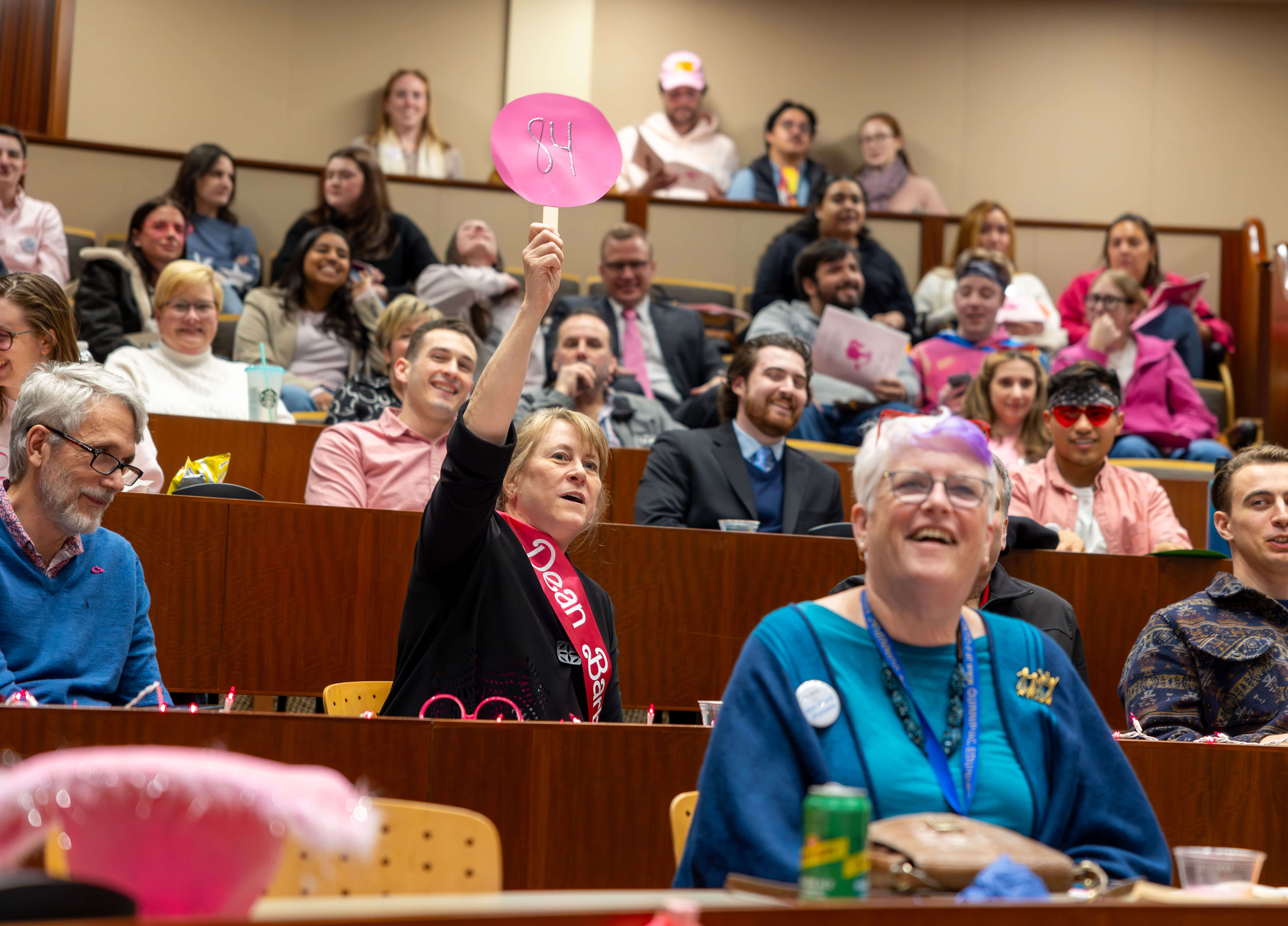 Participants raising auction signs for Public Interest Law Project Auction